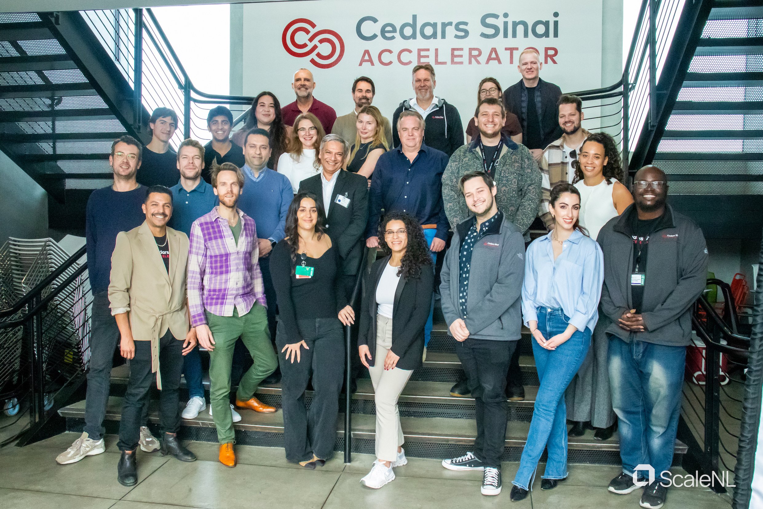 ScaleNL HealthTech Mini Accelerator cohort on the background of Cedars Sinai Accelerator staircase