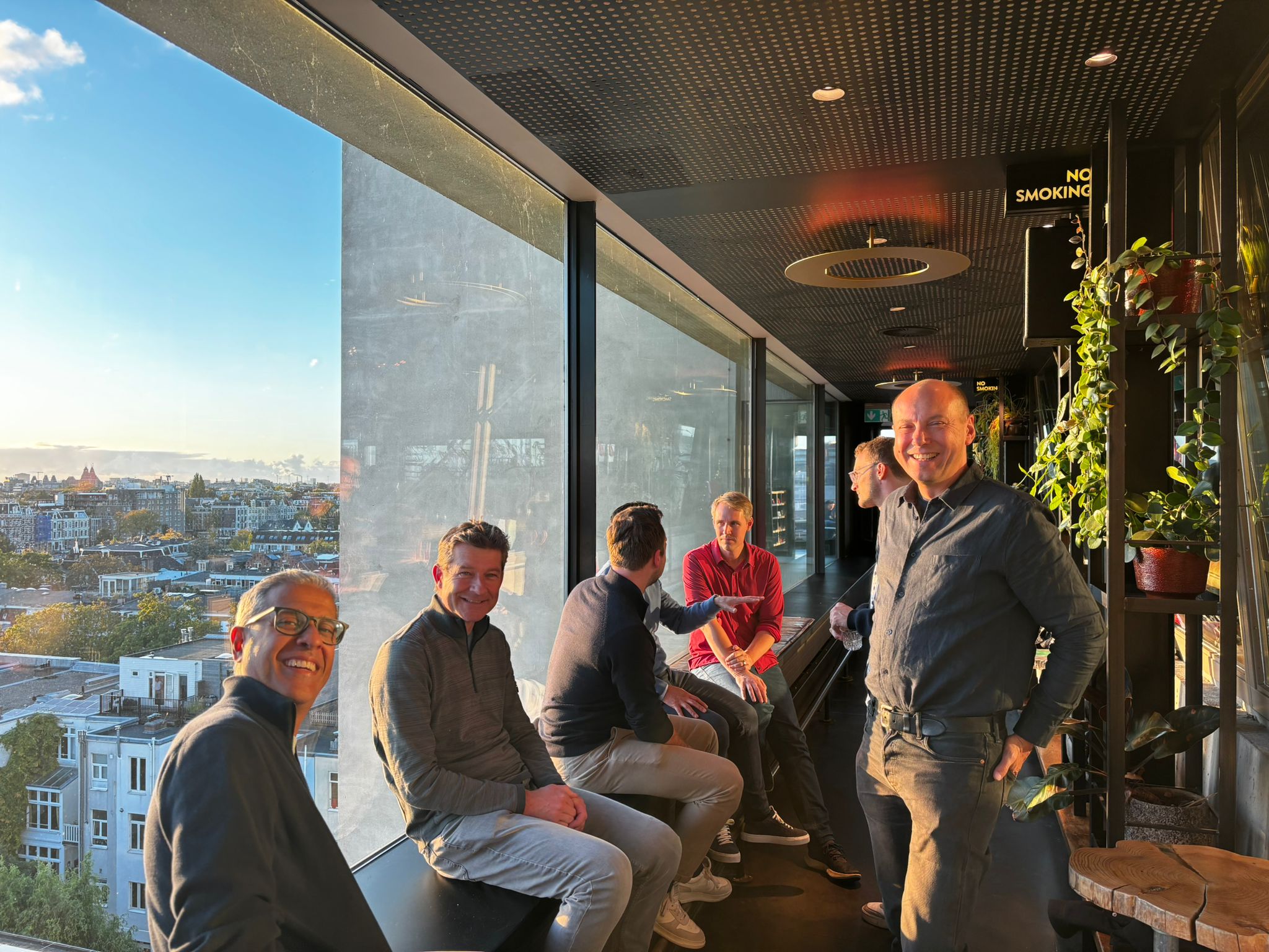 ScaleNL alumni at a high-level floor in a building with a view