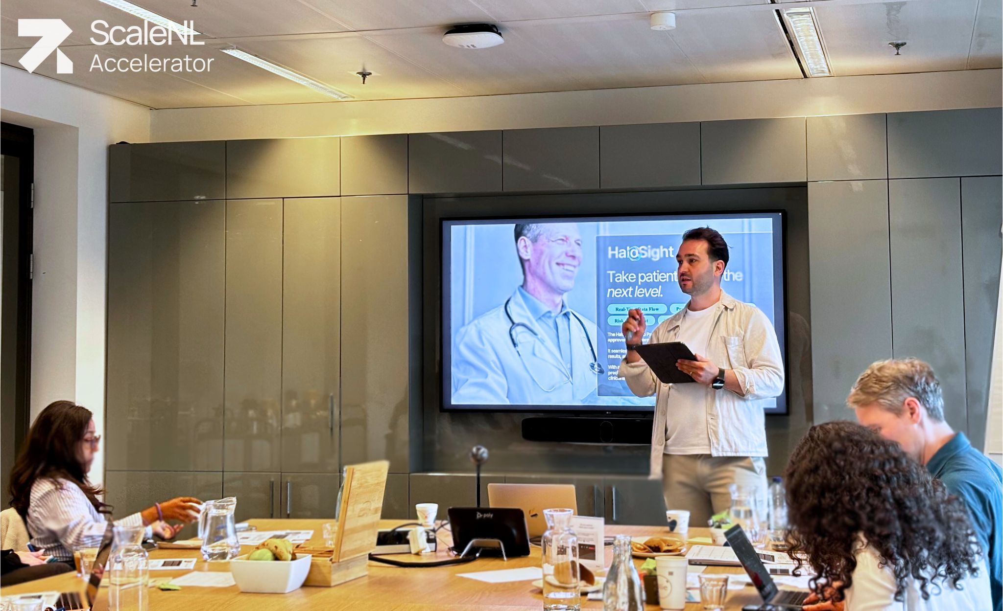 A male startup founder presenting in front of a committee