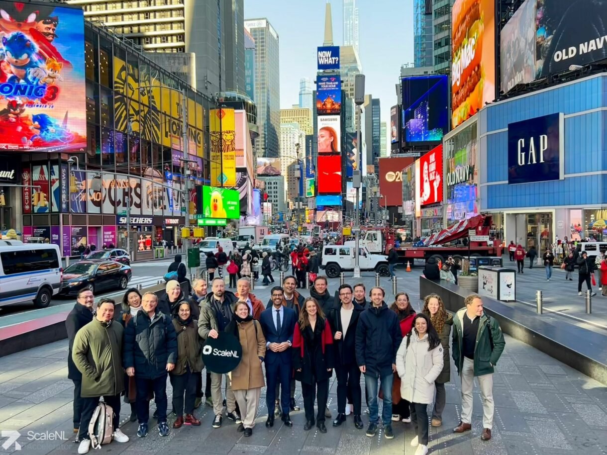 Group Photo on Times Square with neon banners as a backdrop